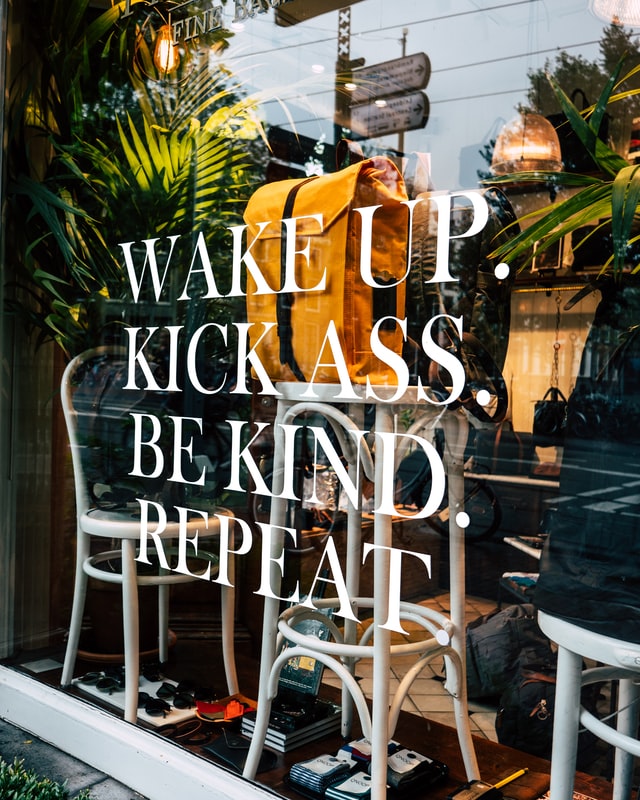 Ein Schaufenster in dem Rucksäcke ausgestellt sind und auf das ein Spruch geklebt wurde