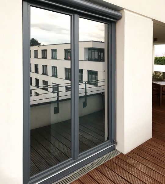 Eine Verandatür aus Glas ist mit silberner Sichtschutzfolie beklebt