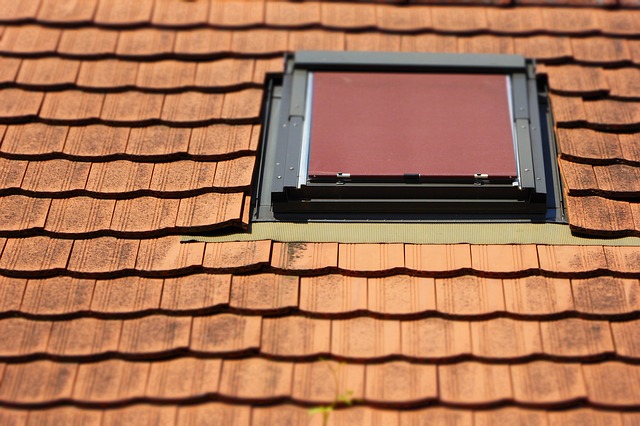 An einem Dachfenster ist außen ein Rollo angebracht