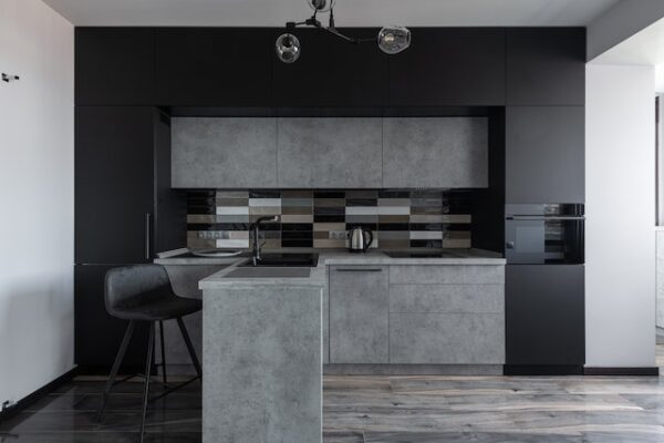 Eine Küche mit grauen, betonarigen und schwarzen Fronten