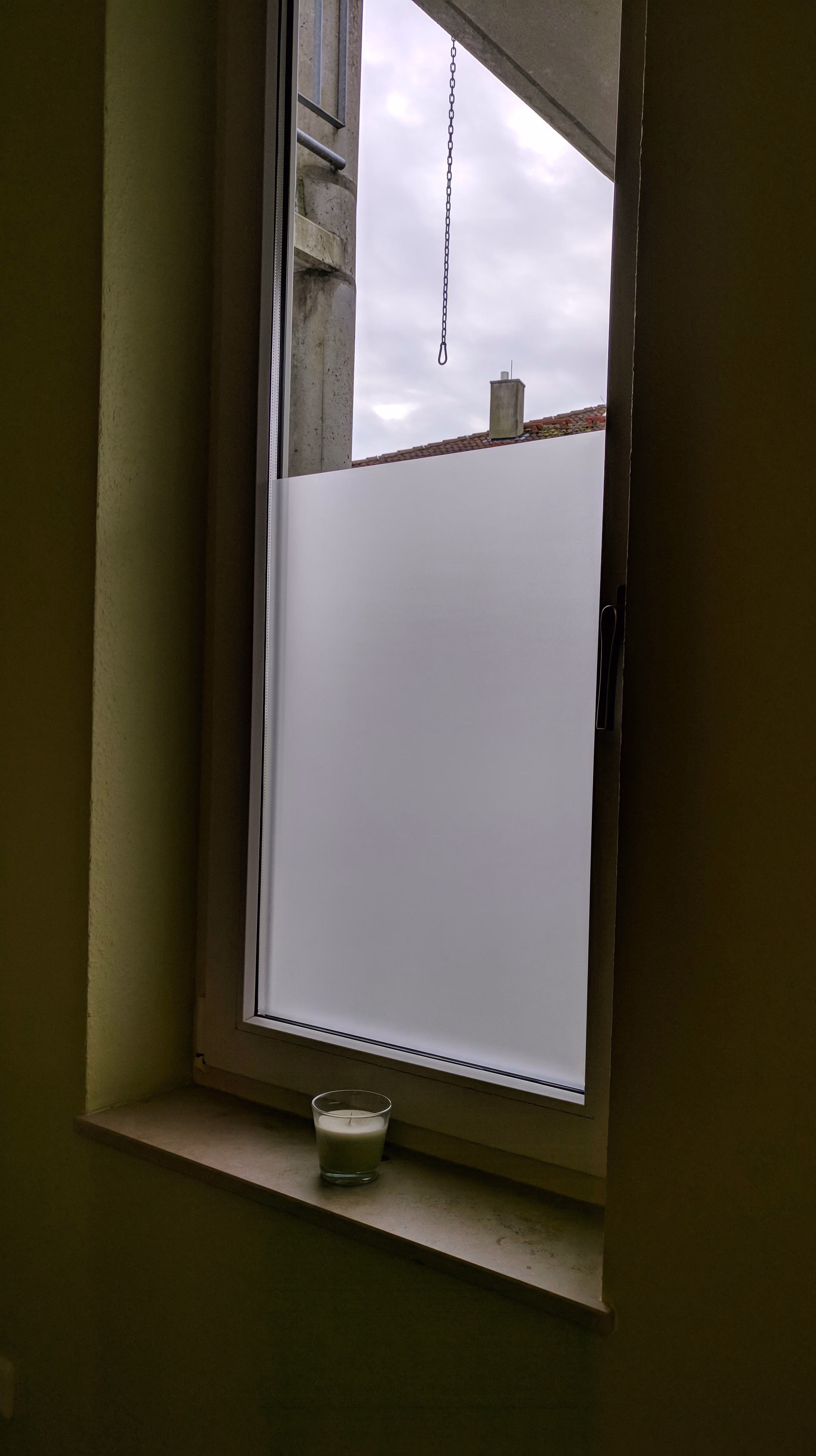 Selbsthaftende Sichtschutzfolie als teilbeklebung auf einem großen Fenster.