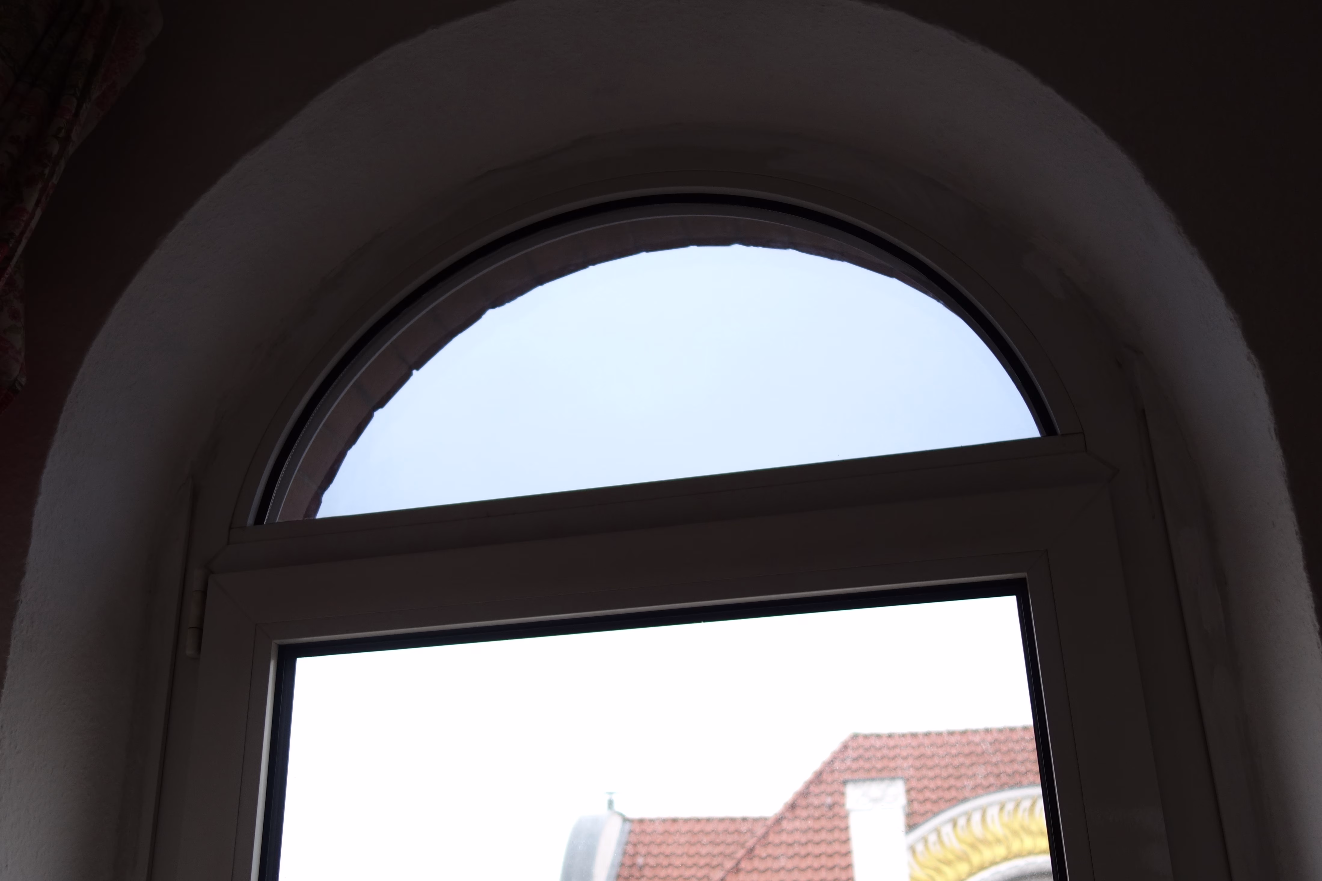 Ein Rundfenster mit angebrachter Sonnenschutzfolie